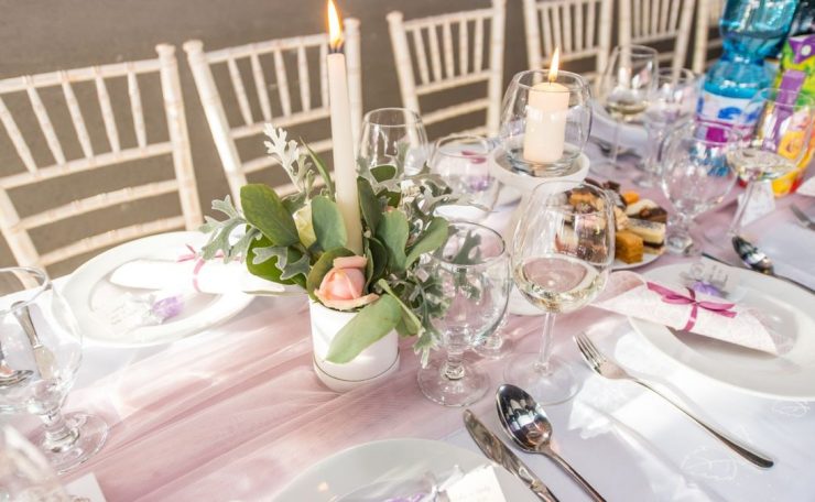Beautifully arranged dining table for an elegant occasion with floral centerpiece and candles.